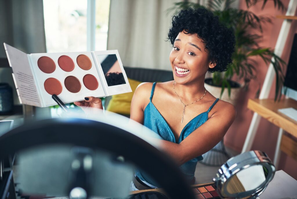 Shot of a influencer recording a makeup tutorial for her blog at home